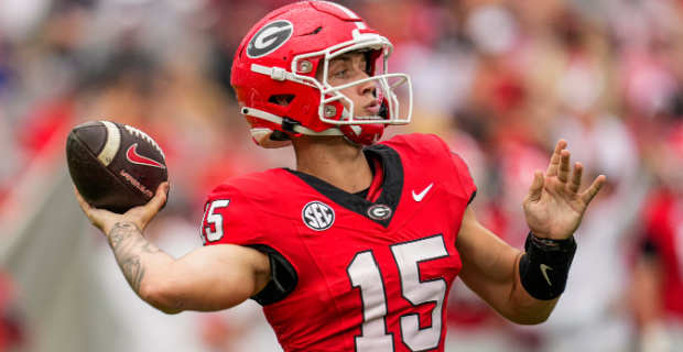 Georgia Bulldogs quarterback Carson Beck attempts a pass during a college football game in the SEC.